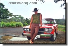 Driver Standing by a Red Car