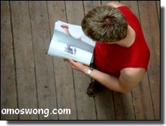 Boy in Red Sleeveless Shirt Reading a Magazine